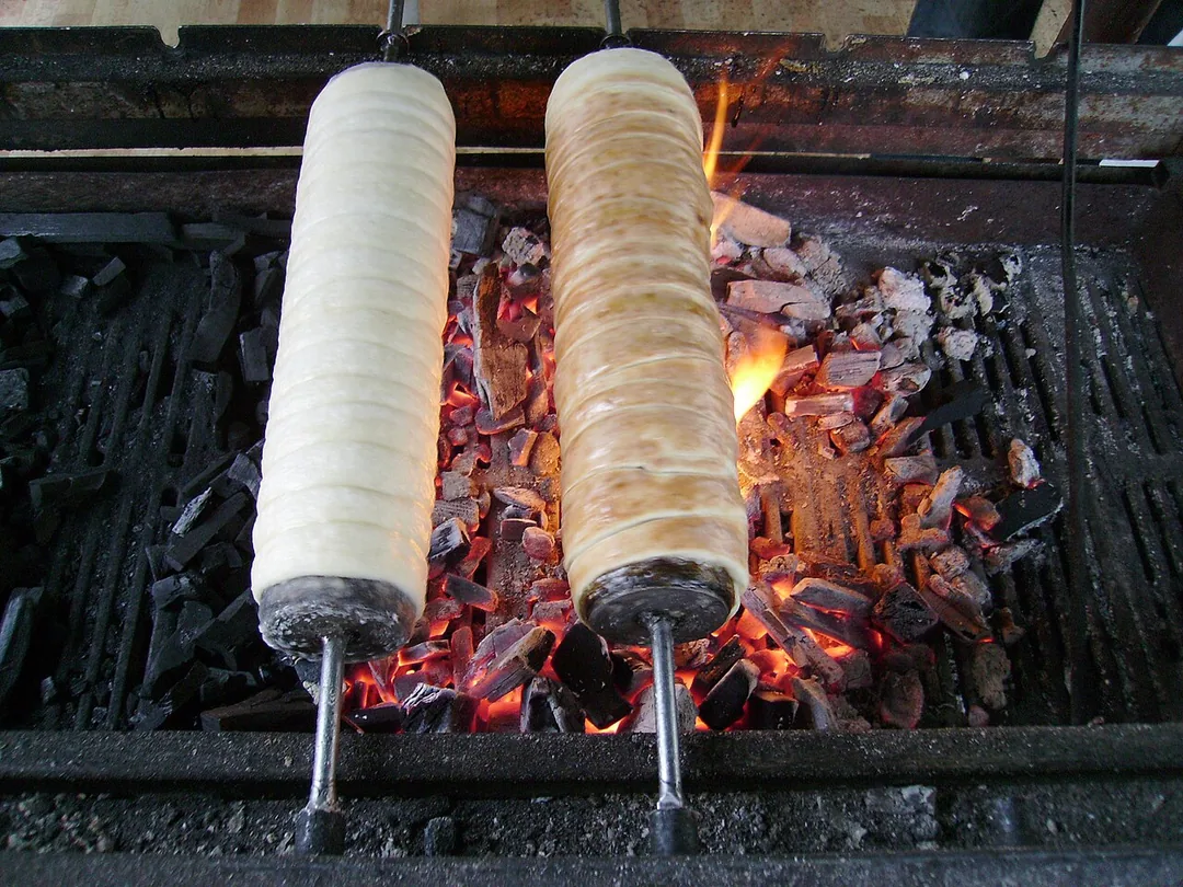 A kurtoskalacs or chimney cake, a spiral of sweet dough roasted golden on a spit and rolled in sugar