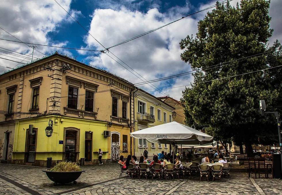 Cafe and restaurant terraces filling Piata Muzeului, the Museum Square in the old town of Cluj-Napoca