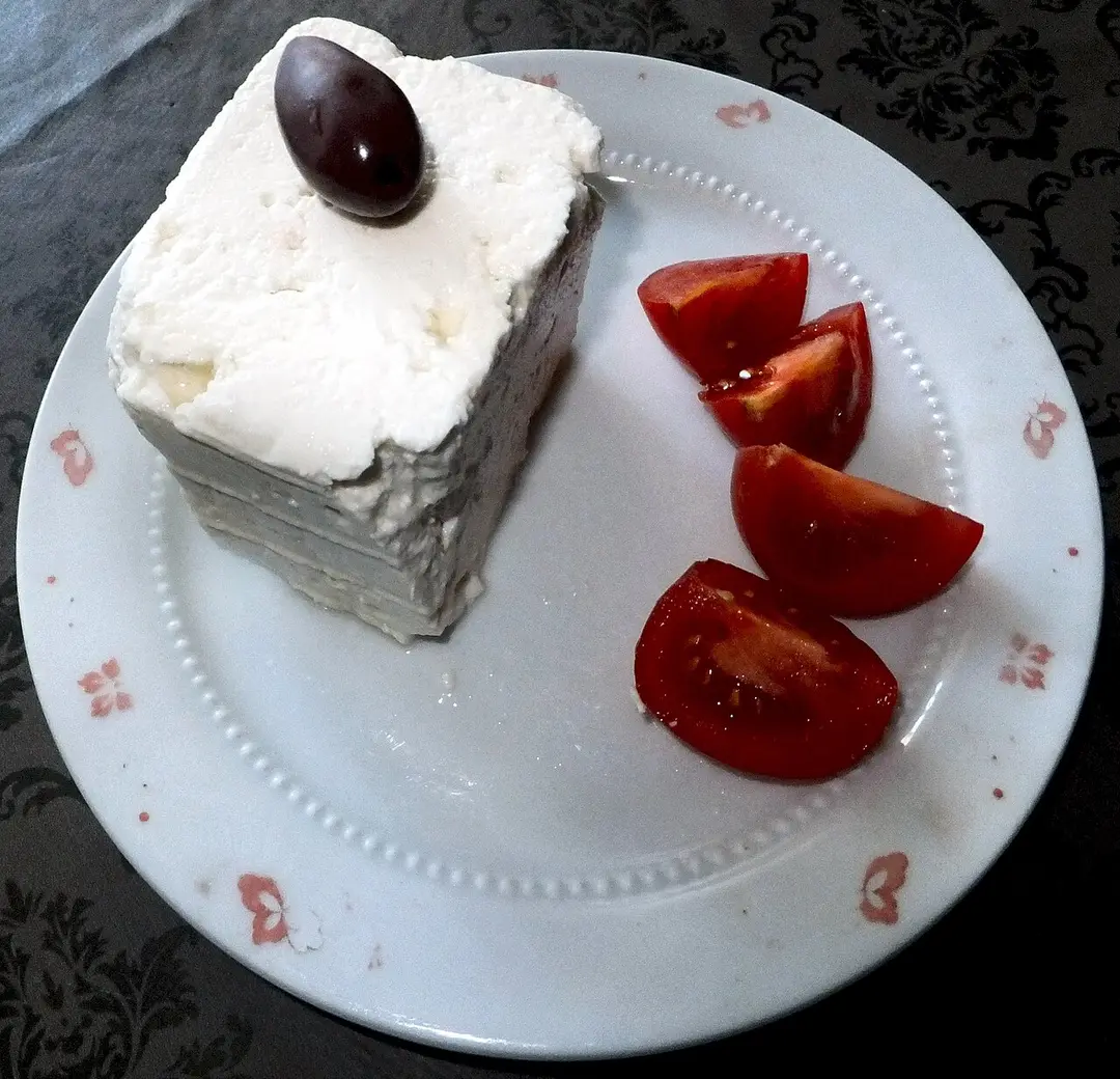 A block of telemea, the semi-hard Romanian sheep cheese, on a wooden board