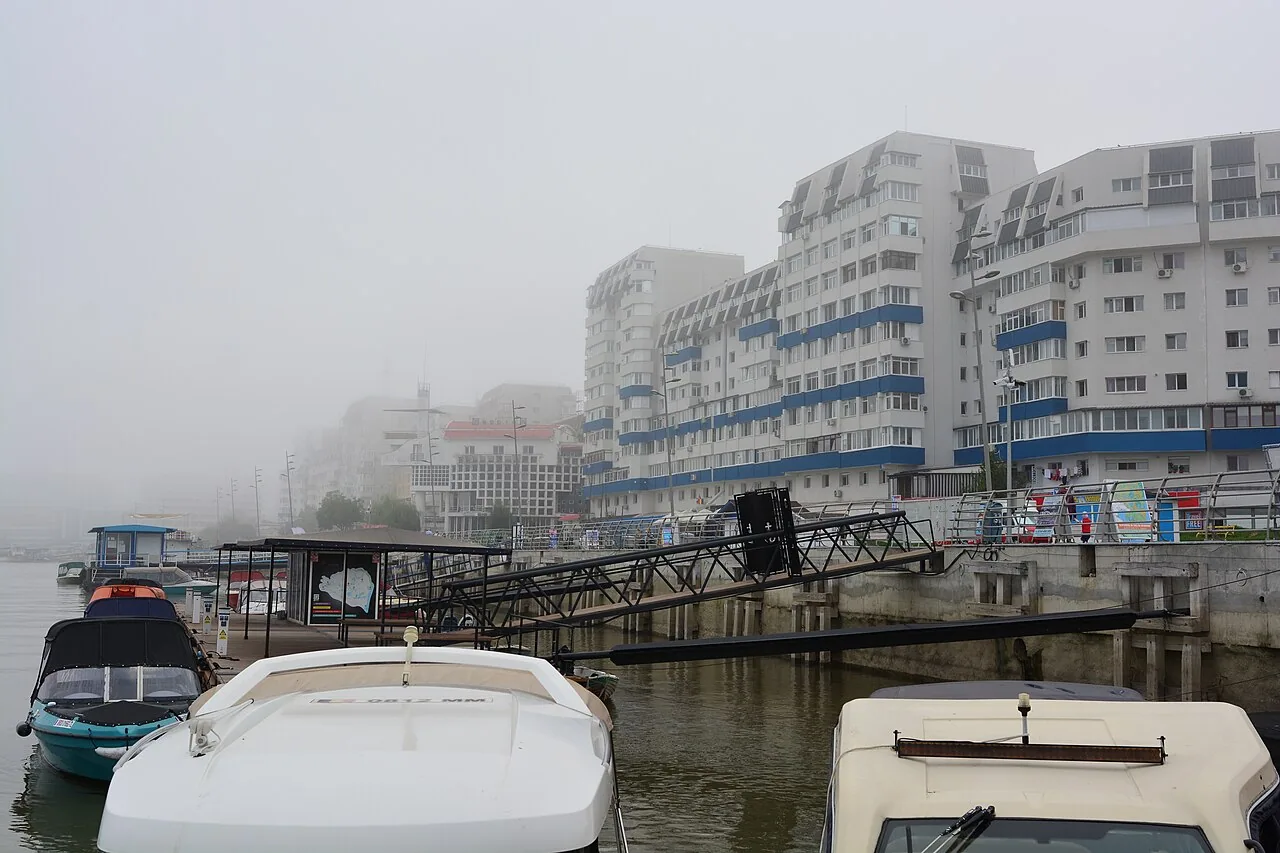 Hotels and docks on the misty Tulcea waterfront along the Danube