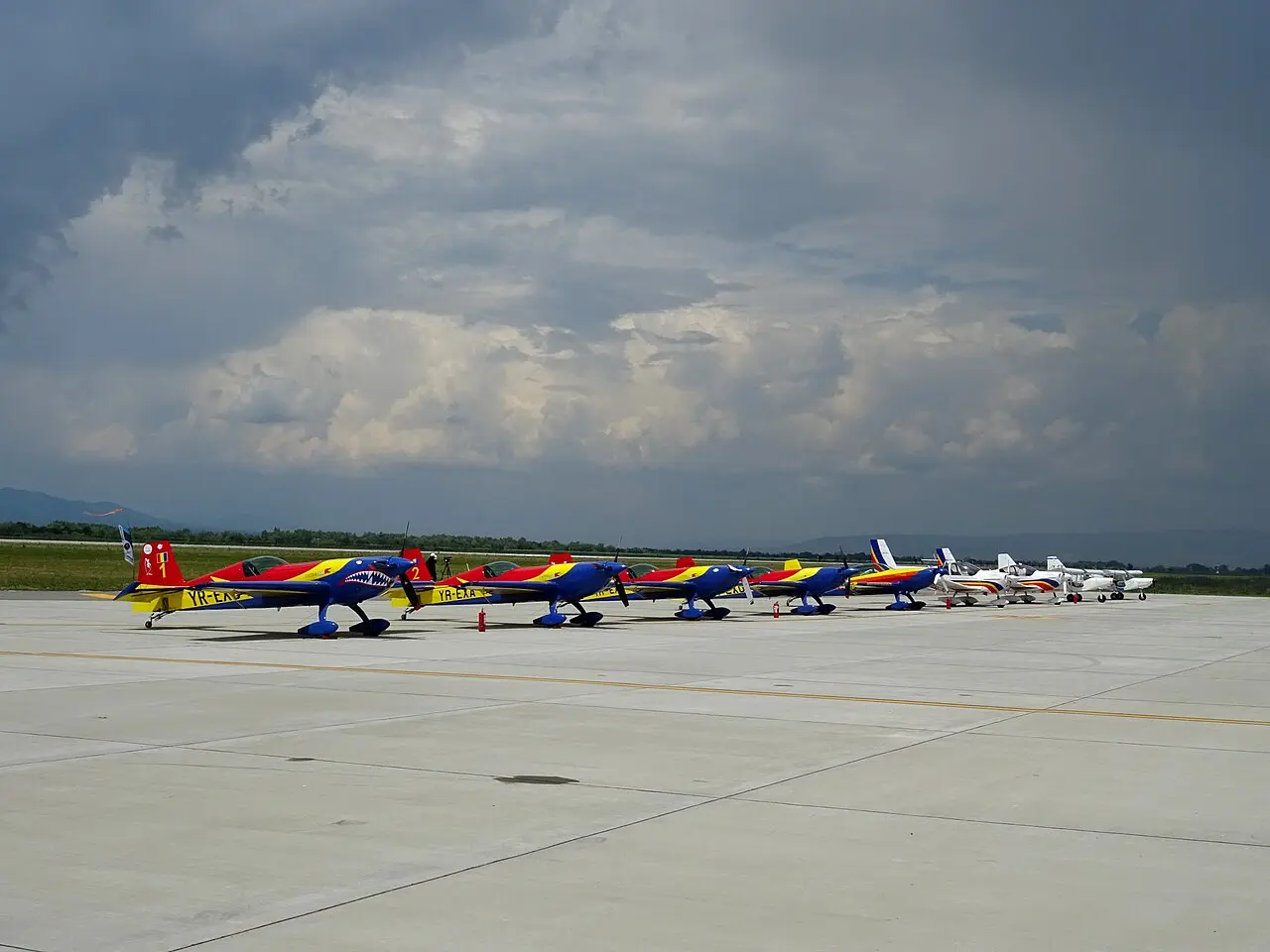 Apron at Brasov-Ghimbav Airport with parked aircraft and terminal buildings beyond