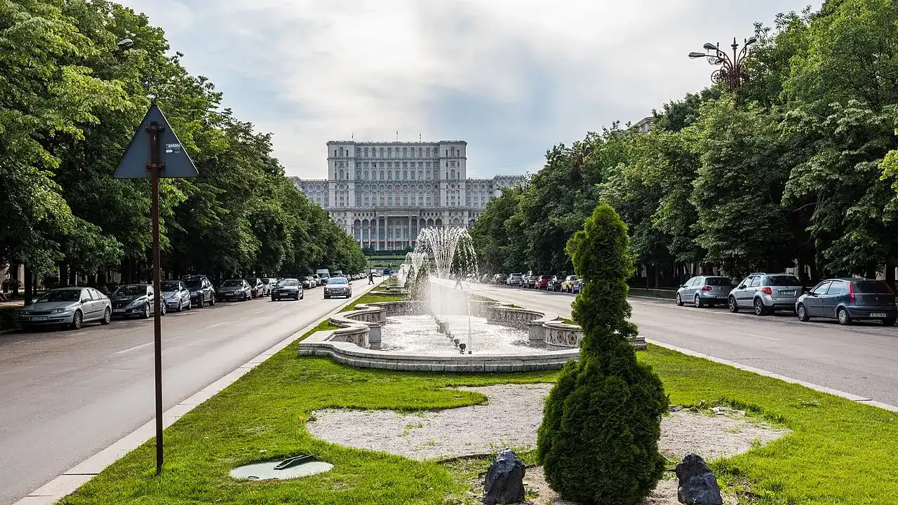 The Palace of the Parliament seen down the tree-lined Union Boulevard with its fountains in Bucharest