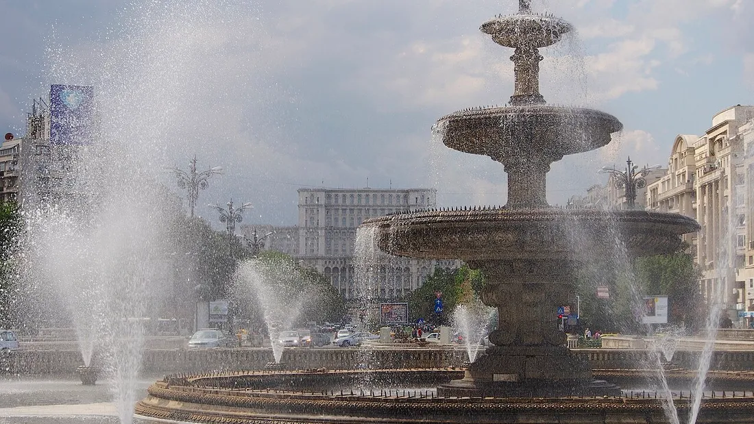 The Palace of the Parliament rising behind the grand fountain of Piata Unirii in Bucharest