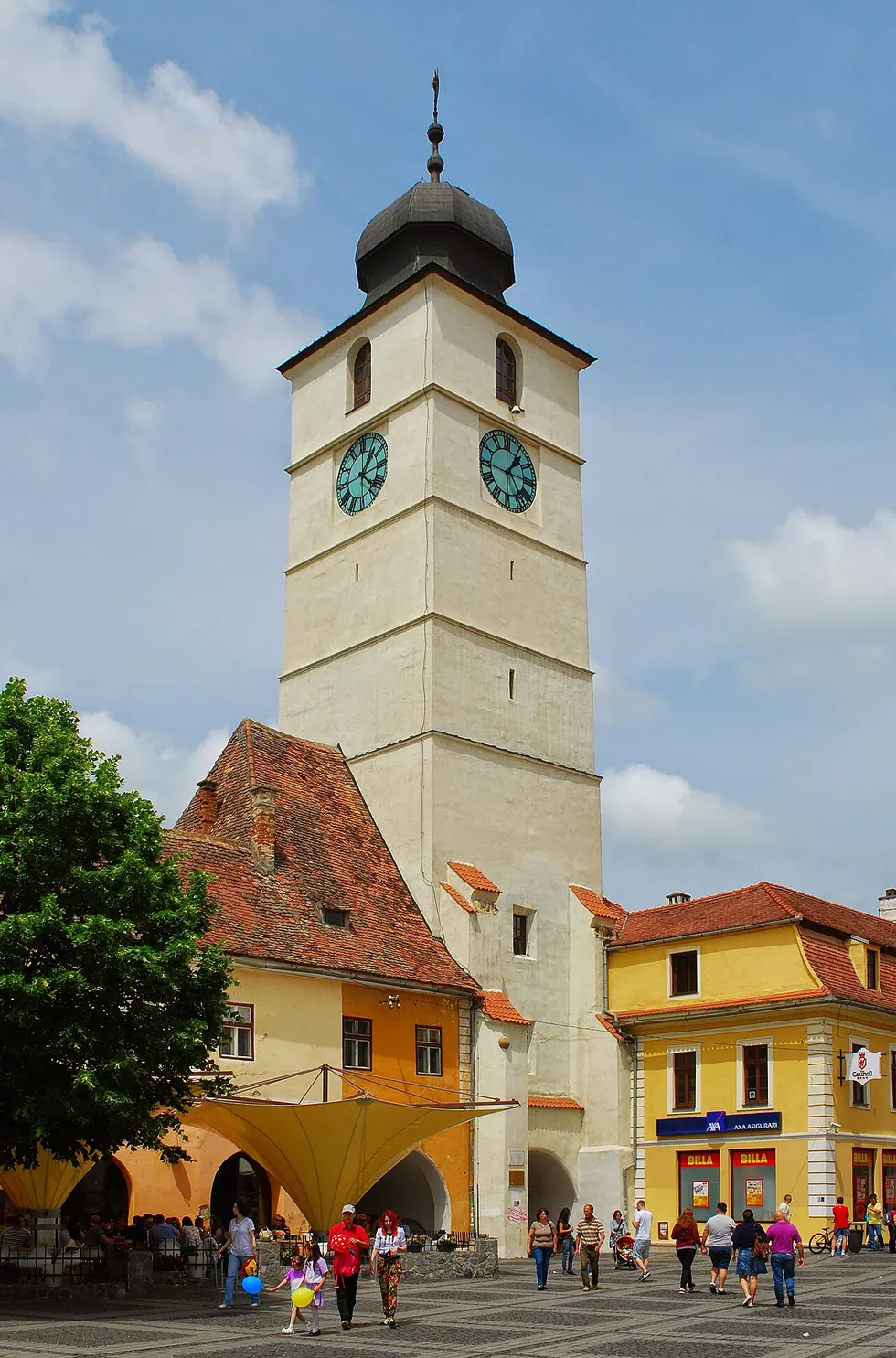 The tall medieval Council Tower (Turnul Sfatului) in Sibiu seen from the Large Square, its clock face catching the light