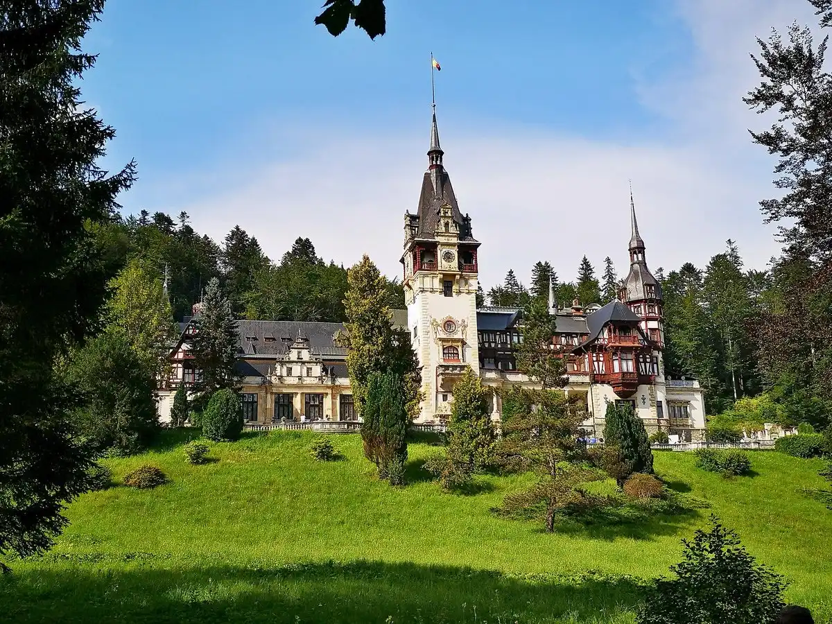 Peles Castle seen through trees in the royal park above Sinaia, the usual goal of a Bucharest day trip