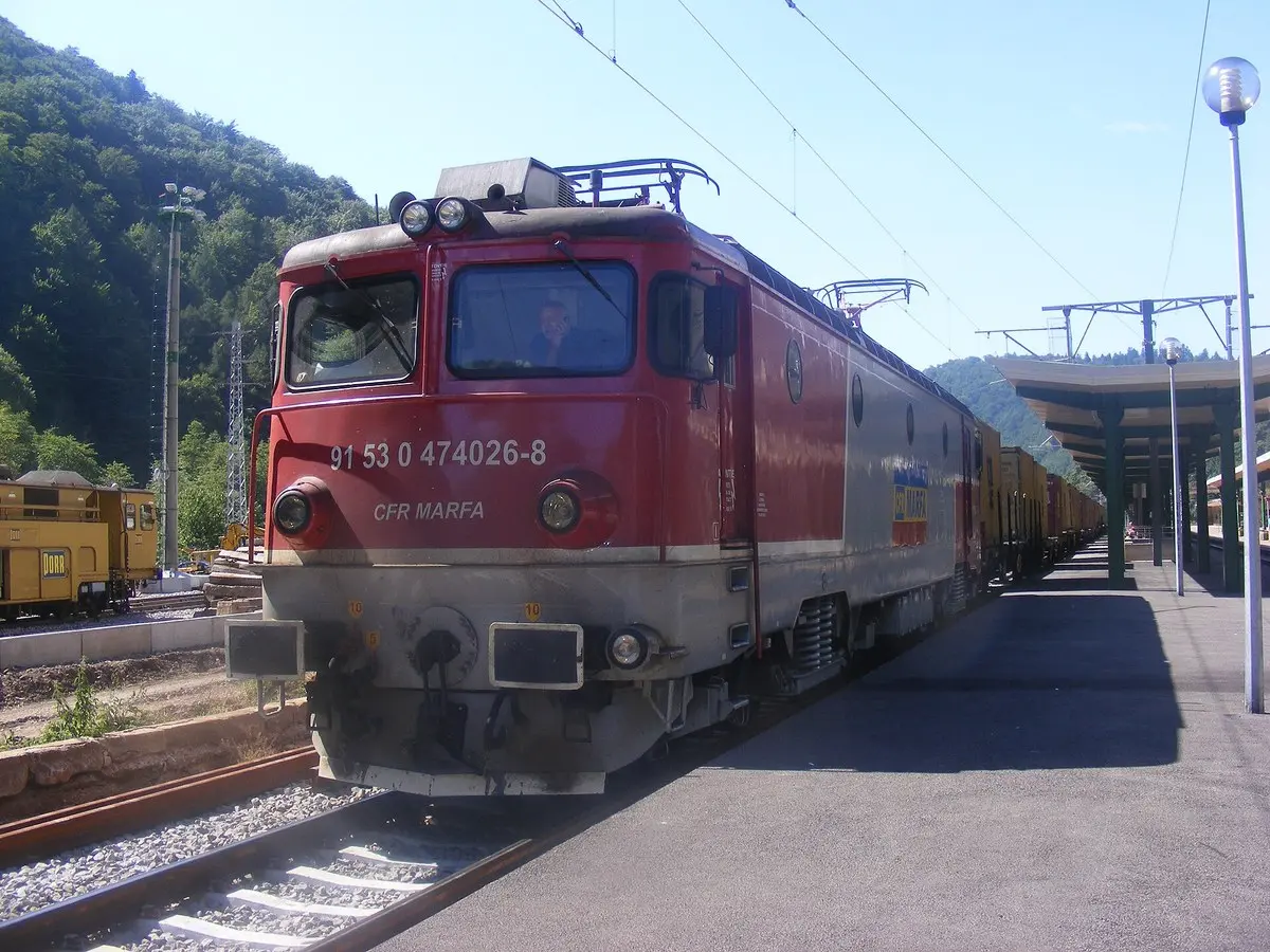 A red CFR electric locomotive standing at the platform in Sinaia station