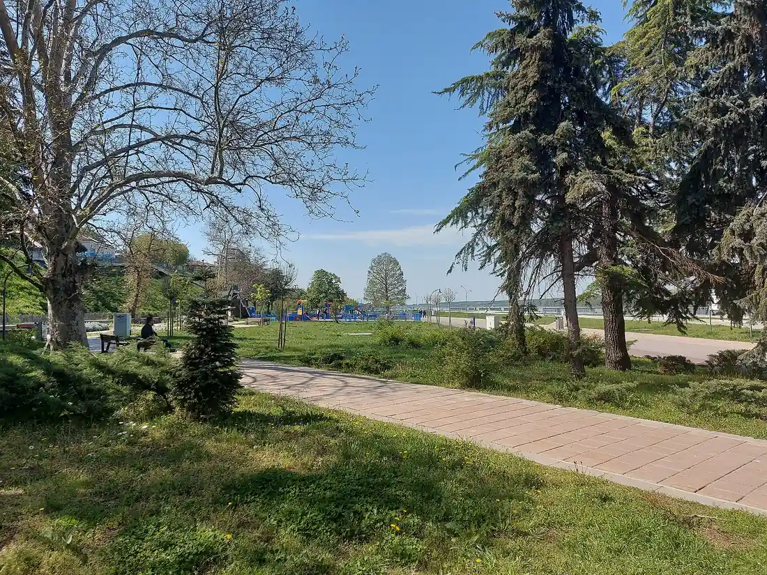 The riverside park in Ruse, Bulgaria, with a paved promenade, benches and the Danube behind - the first Bulgarian city after the bridge