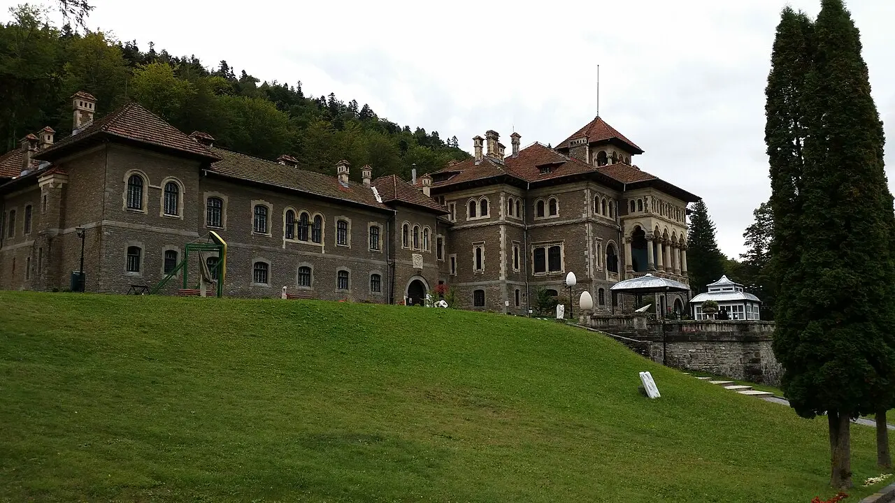 Cantacuzino Castle from the sloping front lawn, the long stone service wing on the left running up to the taller towered residence on the right