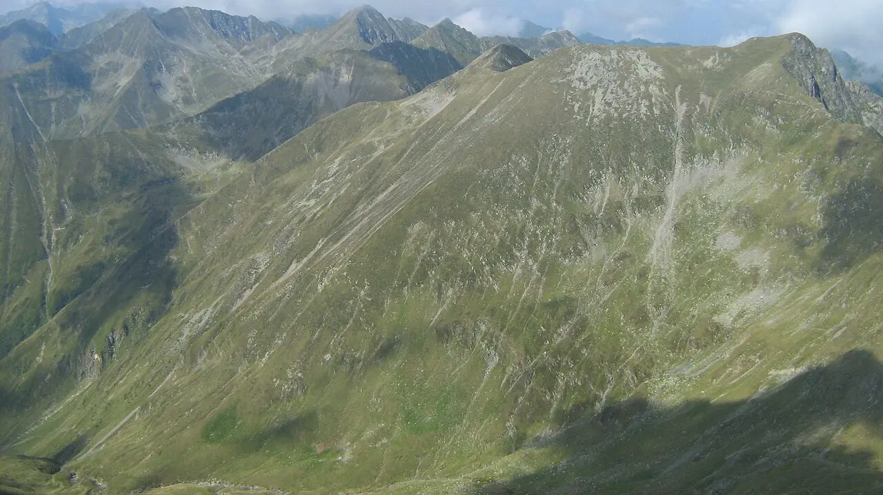 The main ridge of the Fagaras Mountains seen from Moldoveanu, Romania highest peak, a chain of grassy 2500m summits under a clear summer sky