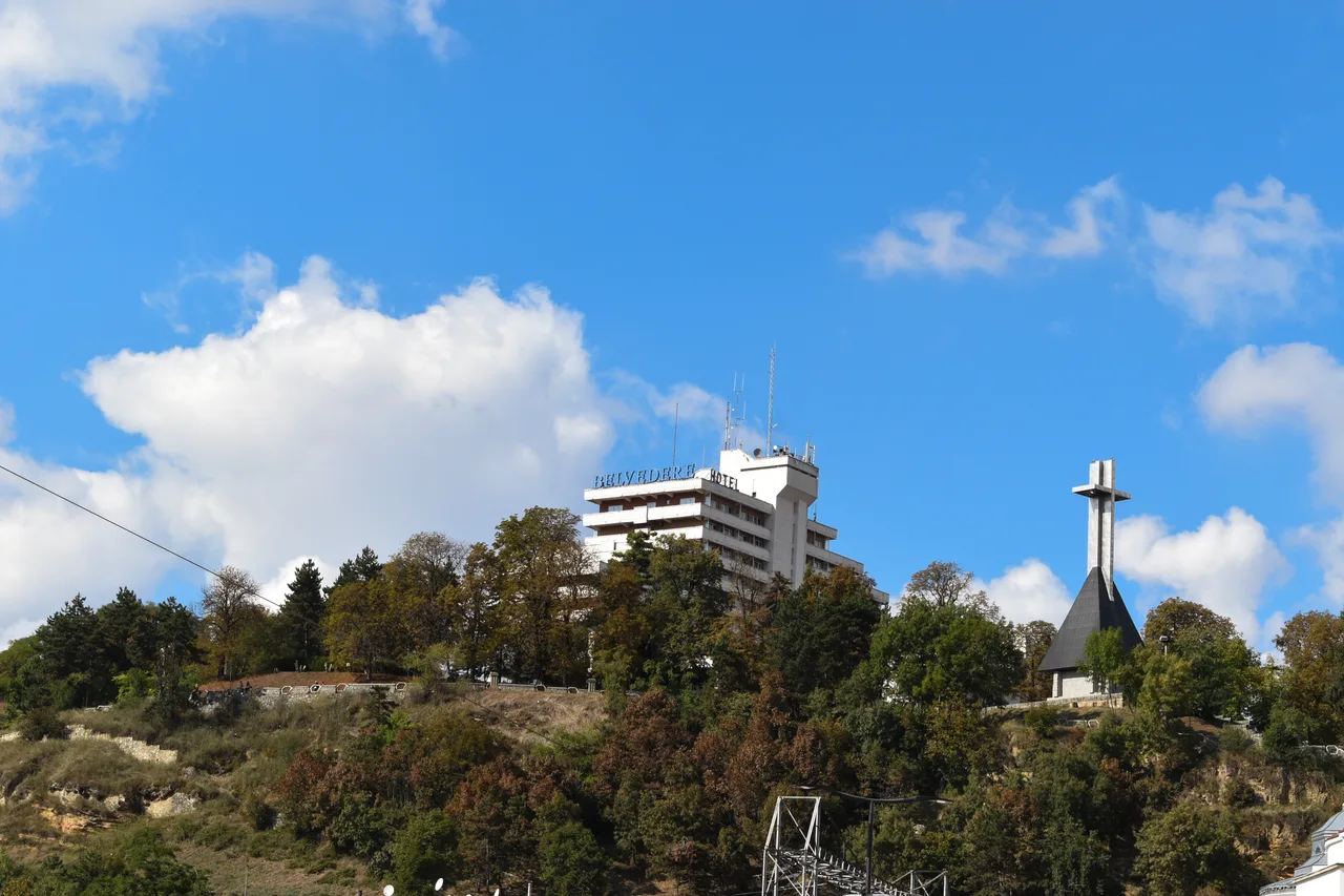 Cetatuia hill above Cluj-Napoca, the Belvedere hotel and the tall memorial cross seen from the old town below