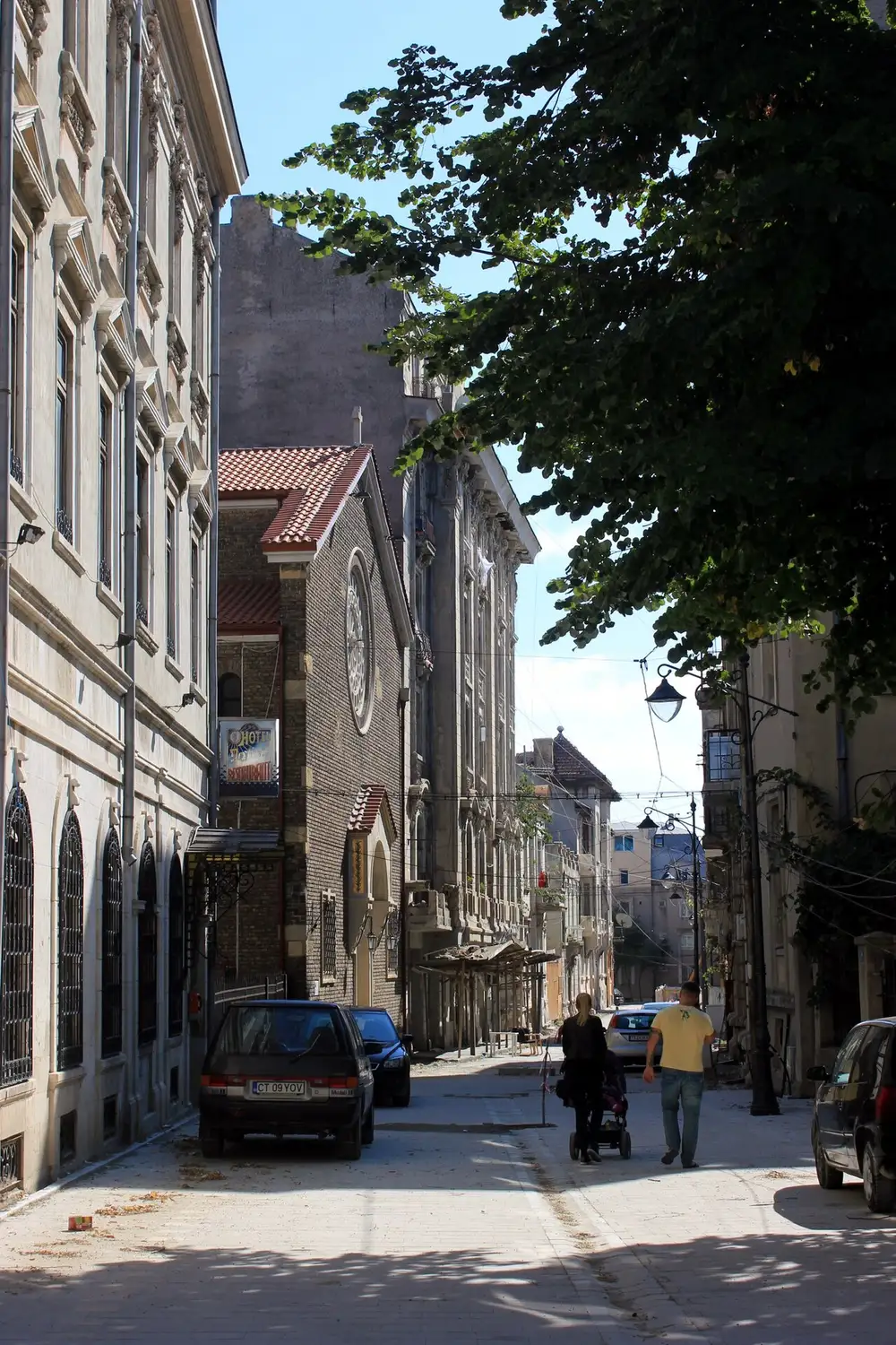 A quiet street of old houses in the Peninsula district of Constanta, some restored and some faded