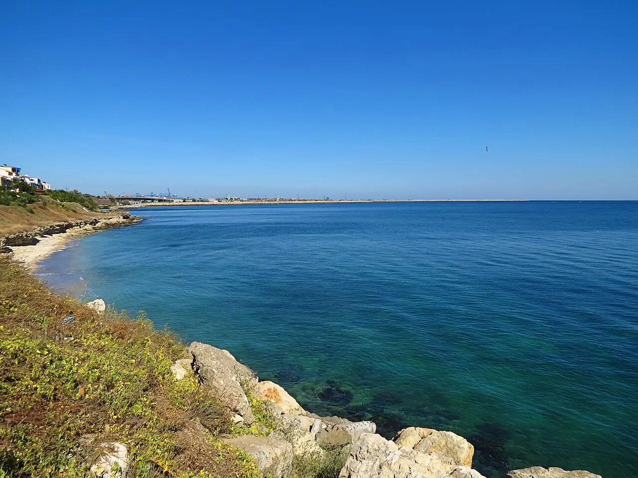 Elevated view from Eforie Nord over roofs toward the Black Sea horizon