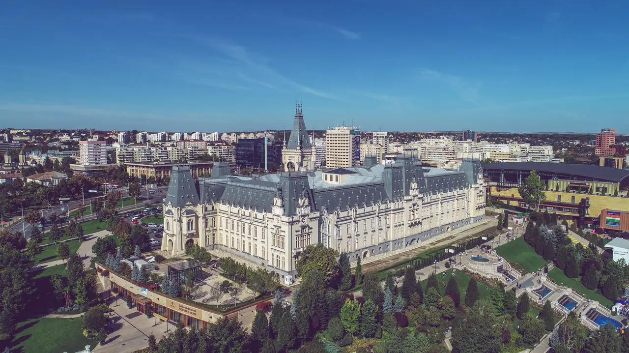 Aerial view of the Neo-Gothic Palace of Culture in Iasi with its tall clock tower rising above the surrounding rooftops