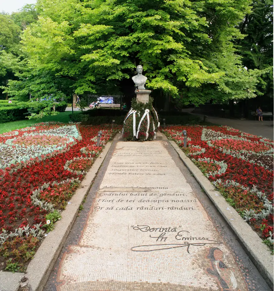 The old silver lime known as Eminescu linden in Copou Park, Iasi, with the poet bust in front of it
