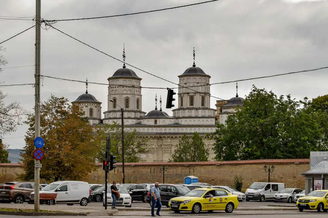The walled ensemble of Golia Monastery in Iasi seen from the street, tower and gatehouse above the wall