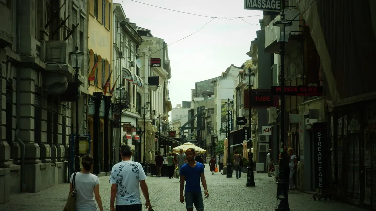 The pedestrian Lipscani street in Bucharest Old Town by day, people strolling past bars and shops, the busiest and most touristy part of the capital
