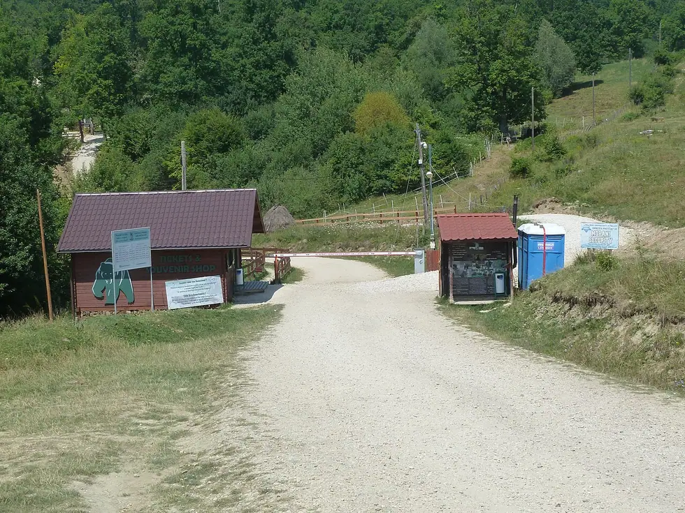 The ticket hut and barrier at the entrance to the Libearty sanctuary at the end of a gravel track