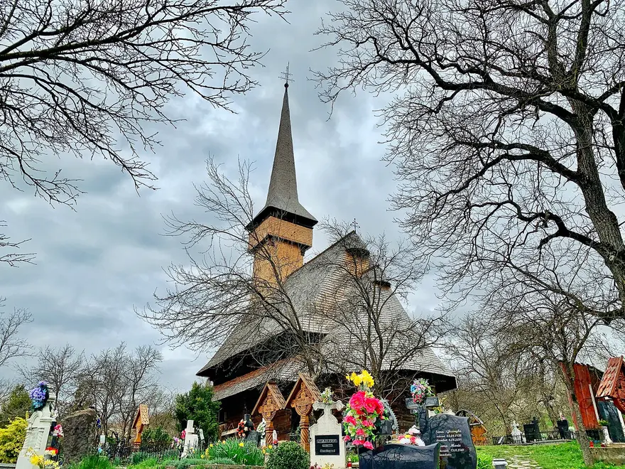 The Saint Parascheva wooden church at Desesti, a UNESCO-listed timber church with a steep shingled roof and slender tower