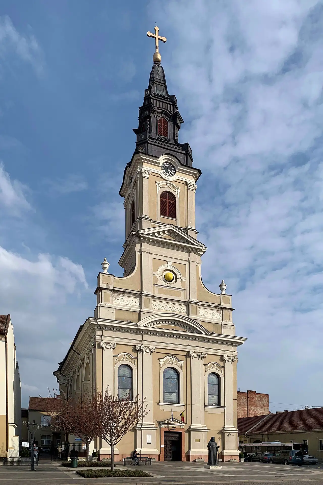 The Moon Church in Oradea, a tall Baroque Orthodox church with a clock tower holding the gold-and-black moon sphere