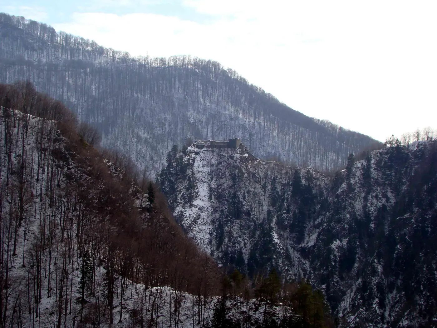 Distant view of Poenari Castle on its crag as seen from the Vidraru Dam side of the Arges valley