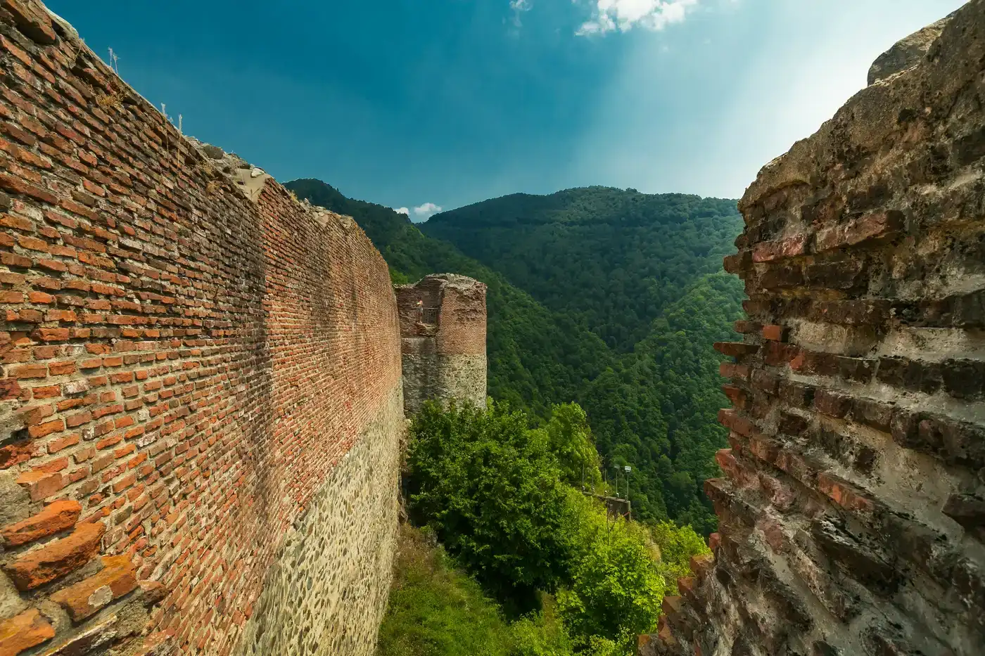 Inside the ruined walls of Poenari Castle, looking along the stone curtain toward open sky