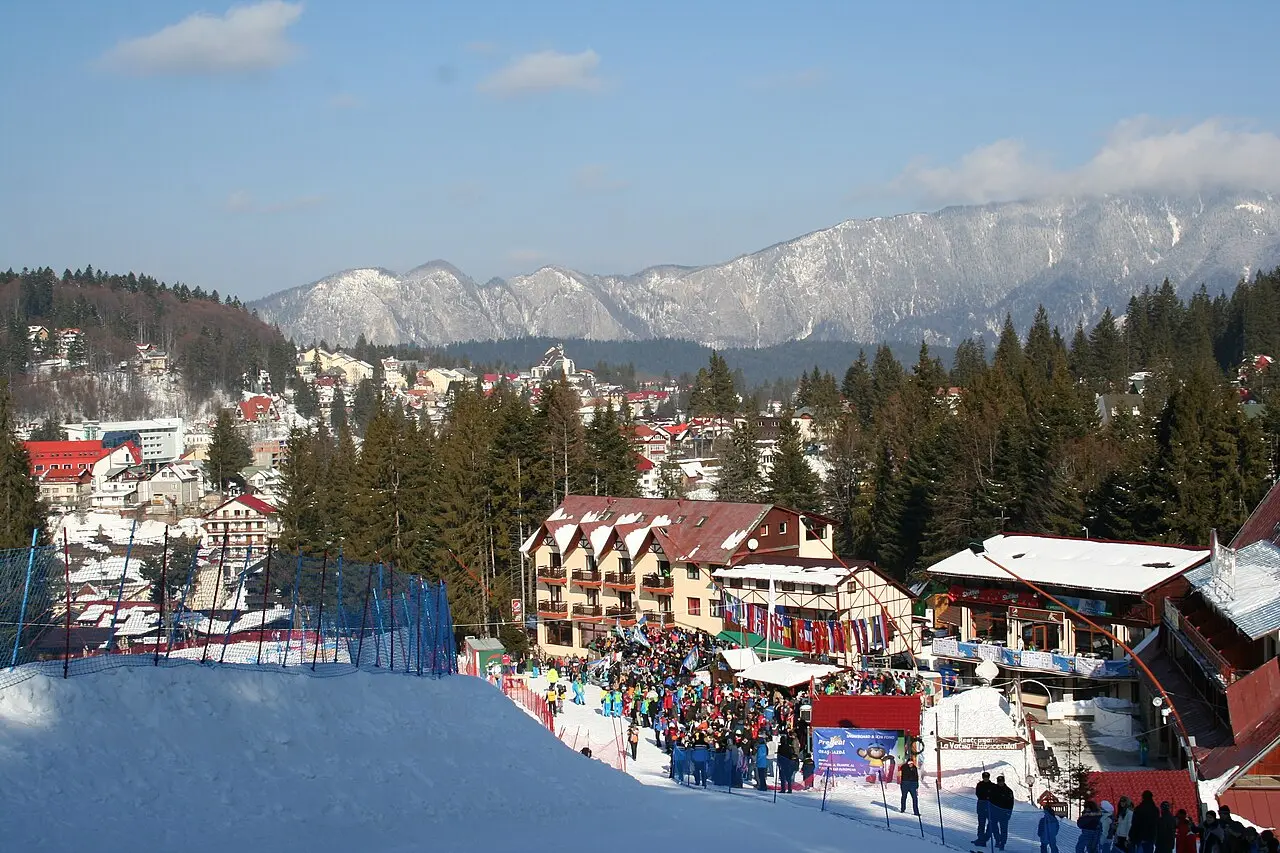 Snow-covered street and timber buildings in Predeal during winter