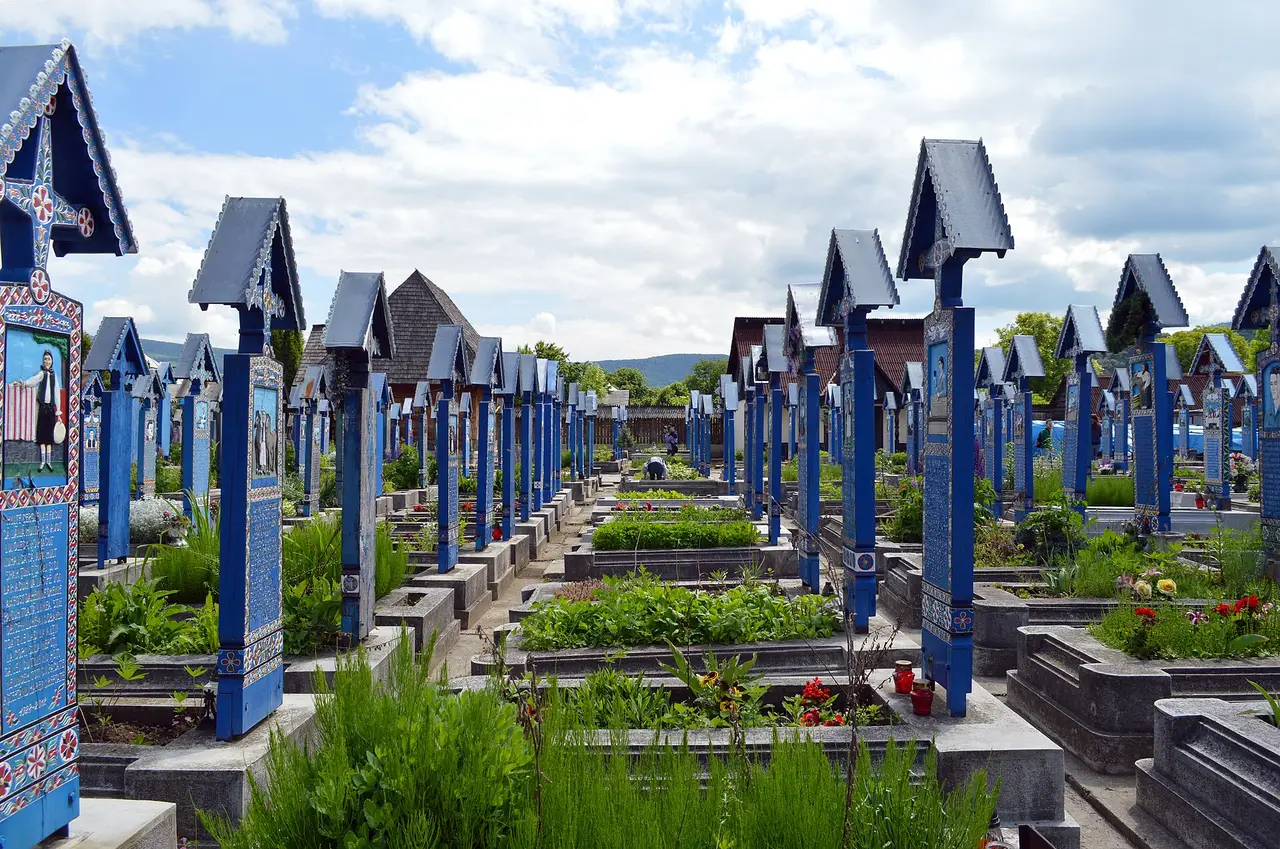 Rows of blue painted wooden crosses with small carved scenes at the Merry Cemetery in Sapanta, Maramures