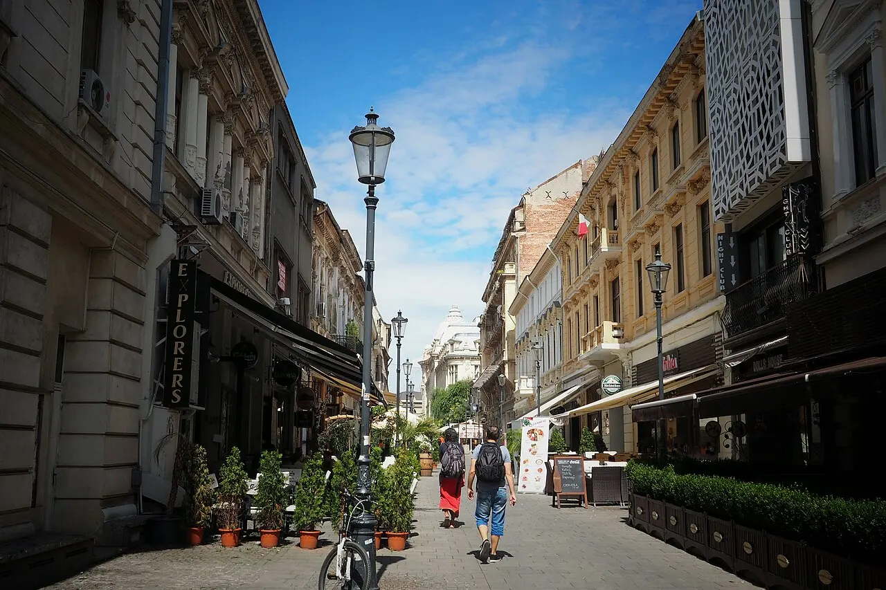 A restored old-town street in central Bucharest, the kind of pedestrian lane lined with cafes and terraces where daily spending adds up