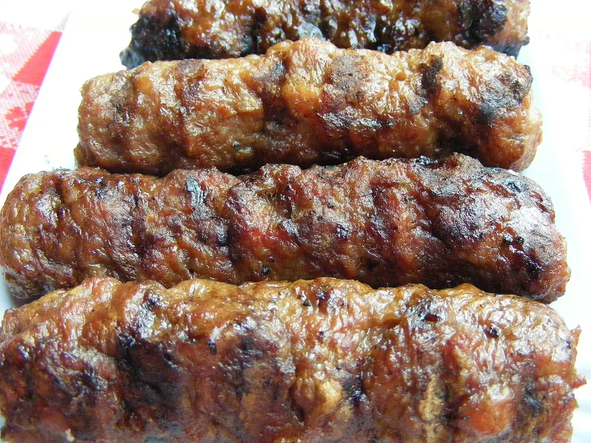 Mici, the Romanian skinless grilled sausages, cooking over charcoal, a cheap and filling street-food staple
