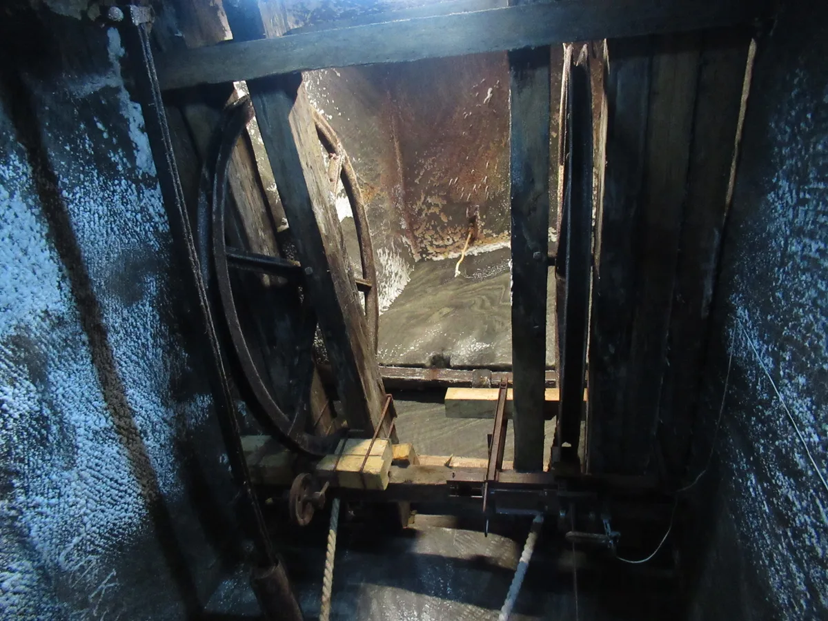 The old wooden extraction winch (crivac) preserved in a salt-crusted chamber of Salina Turda