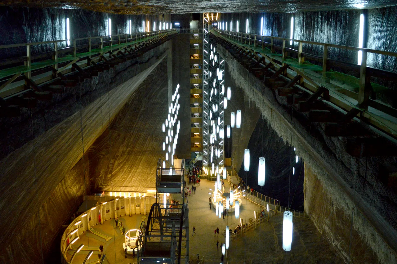 The Rudolf mine seen from the upper viewing gallery, hanging light cylinders dropping into the pit and the panorama wheel below