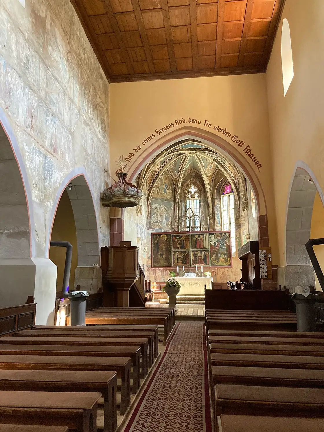 The 14th-century Gothic frescoes covering the walls inside the fortified church of Malancrav