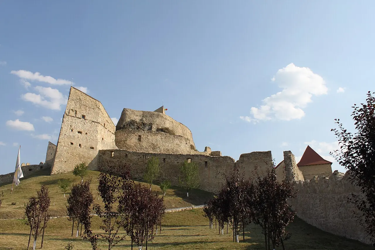 The restored ringed walls and towers of Rupea Fortress on its hilltop
