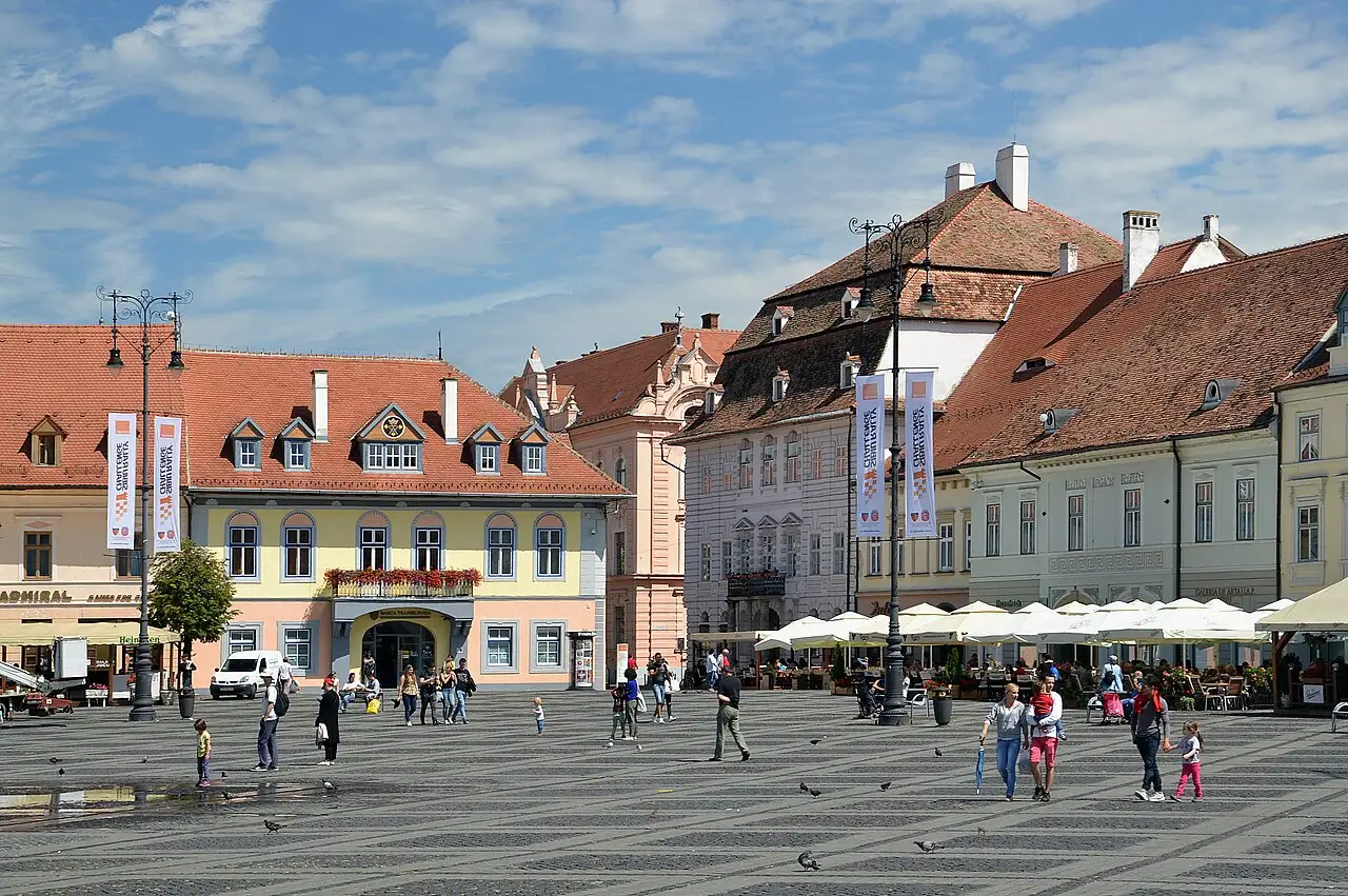 The Large Square of Sibiu ringed by pastel Saxon houses and the Council Tower