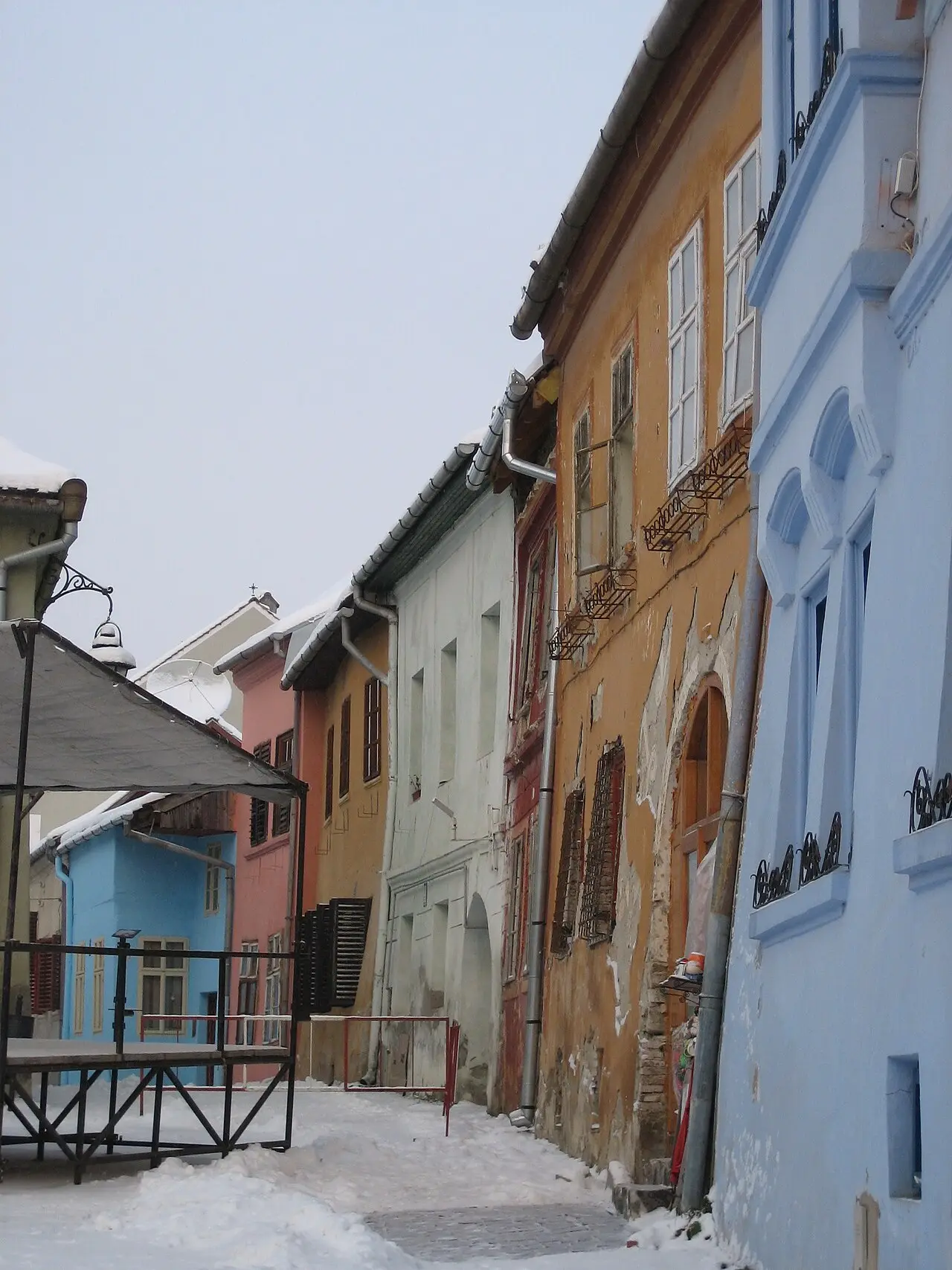 Piata Cetatii, the citadel square in Sighisoara, ringed by pastel merchant houses