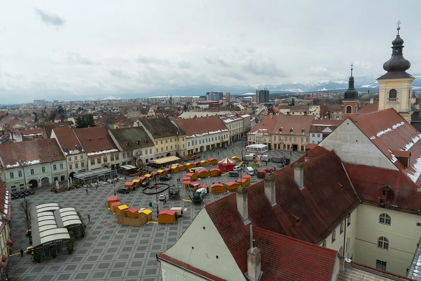 The Large Square of Sibiu seen from the Council Tower, red roofs stretching to the Fagaras Mountains on the horizon