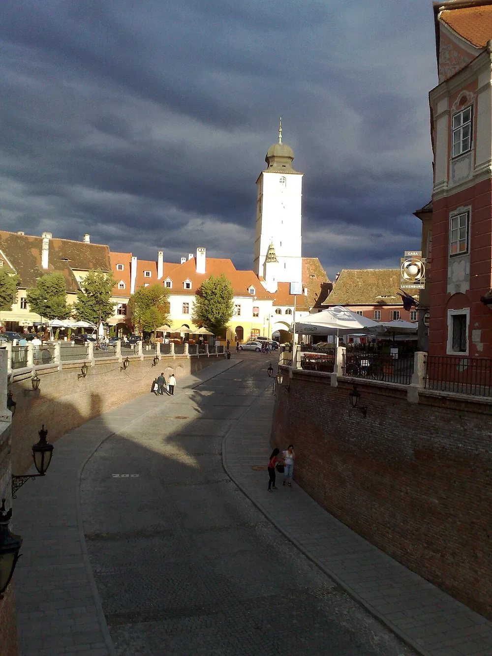 The Council Tower of Sibiu seen from the Bridge of Lies, framed by tiled roofs
