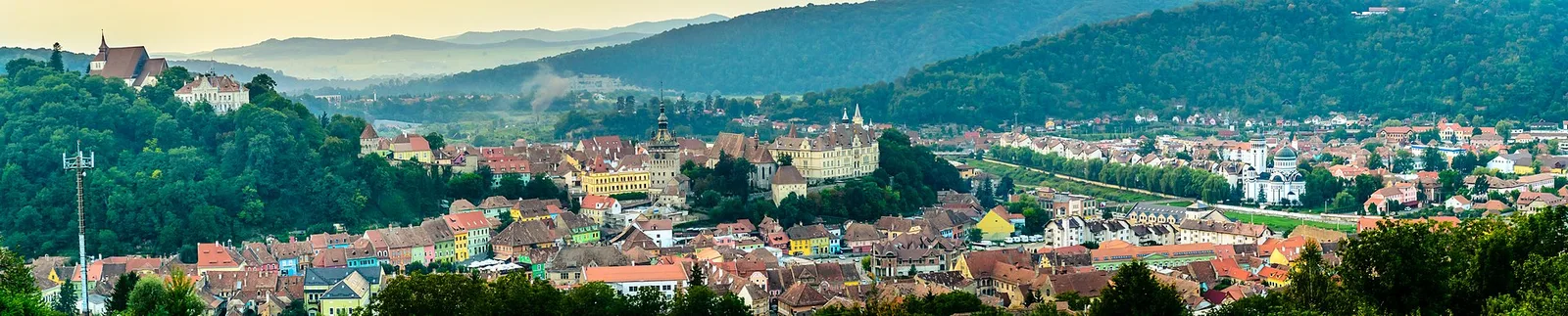 Panorama of the Sighisoara citadel on its hill, the Clock Tower rising above a cluster of red-tiled Saxon houses