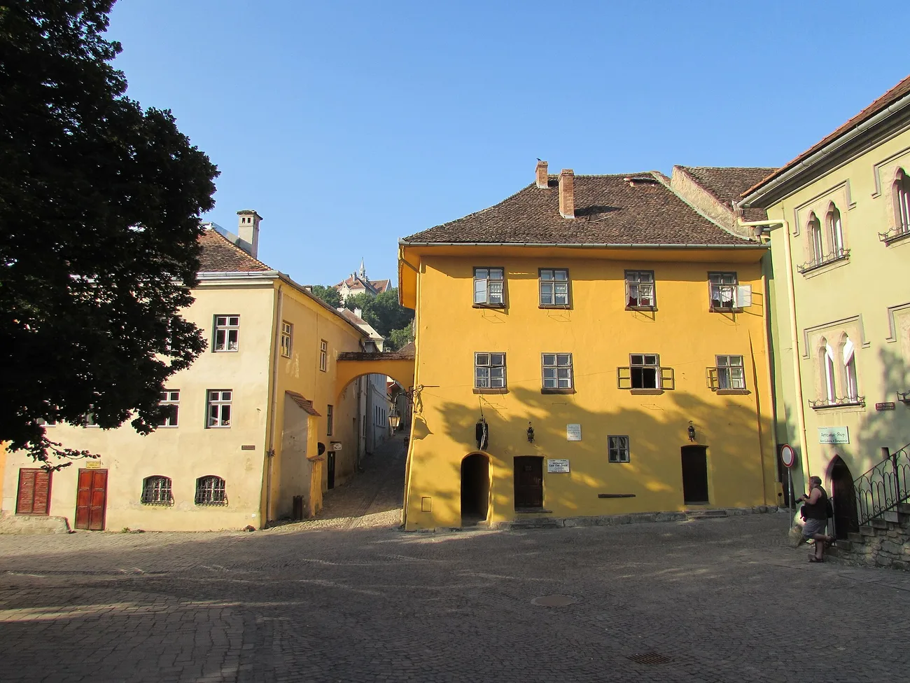 Casa Vlad Dracul in Sighisoara, an ochre-coloured medieval house on the citadel square with a wrought-iron dragon sign