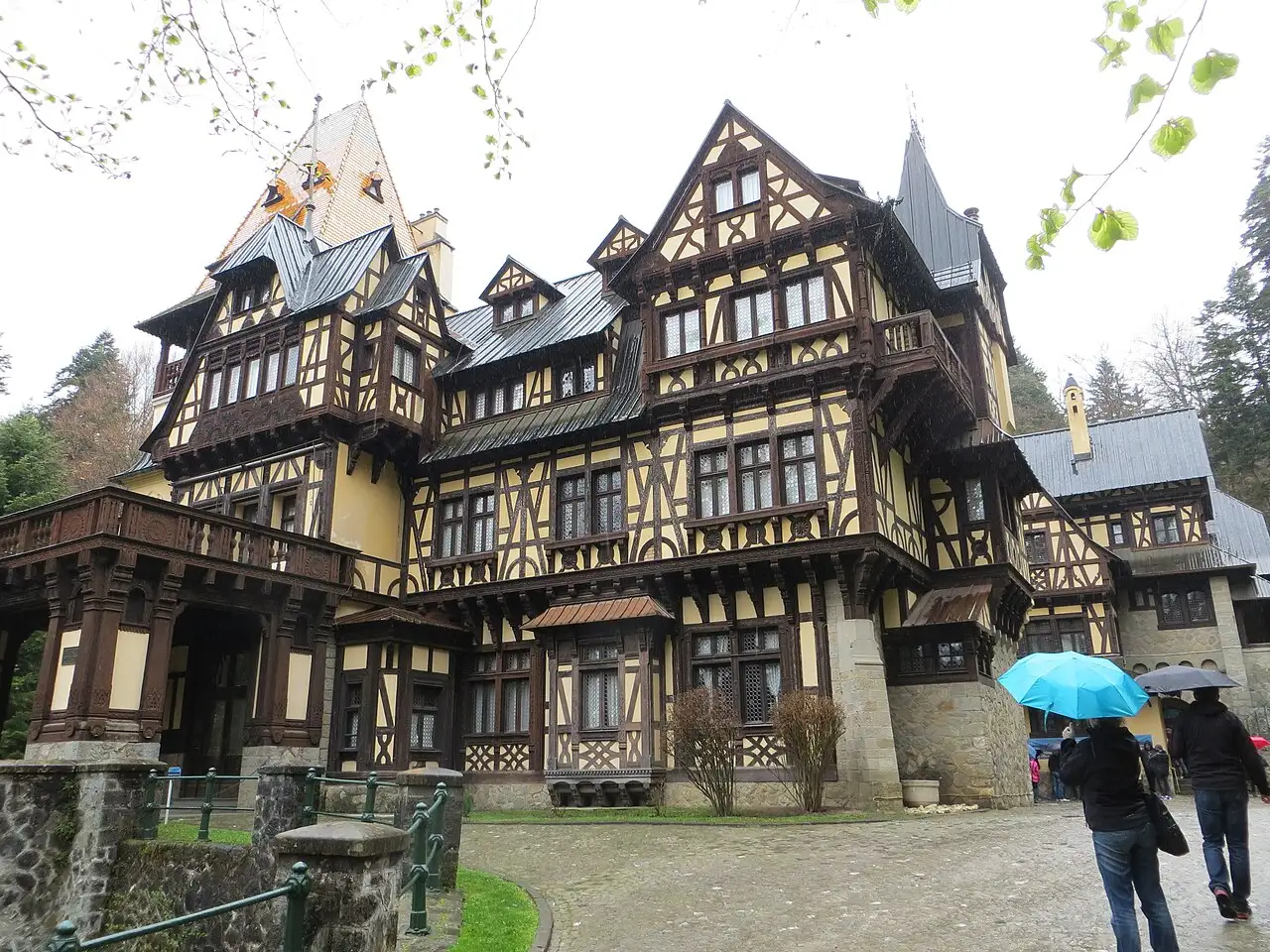 Pelisor Castle near Sinaia, a half-timbered Art Nouveau villa with steep gables and dark carved woodwork among trees