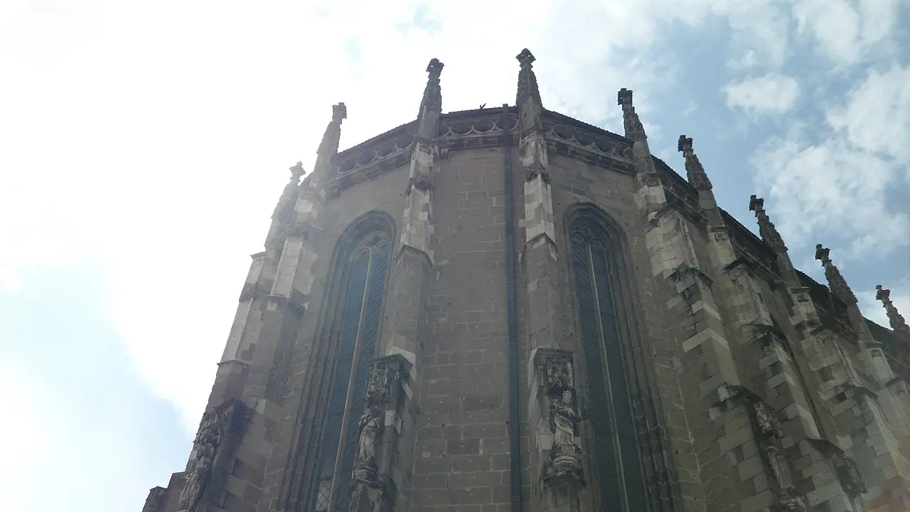 The tall tower of the Black Church in Brasov against a blue sky