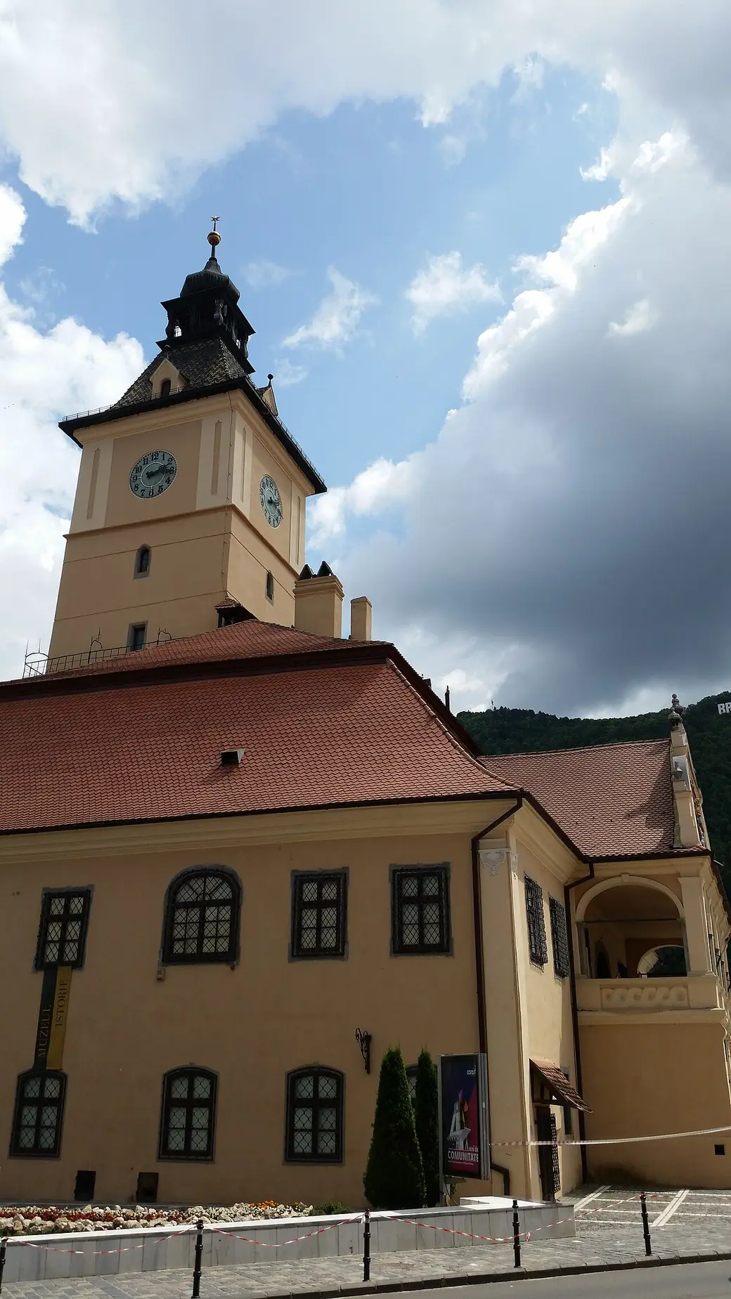 The Council House (Casa Sfatului) in Brasov, a tall ochre building topped by the Trumpeter's Tower