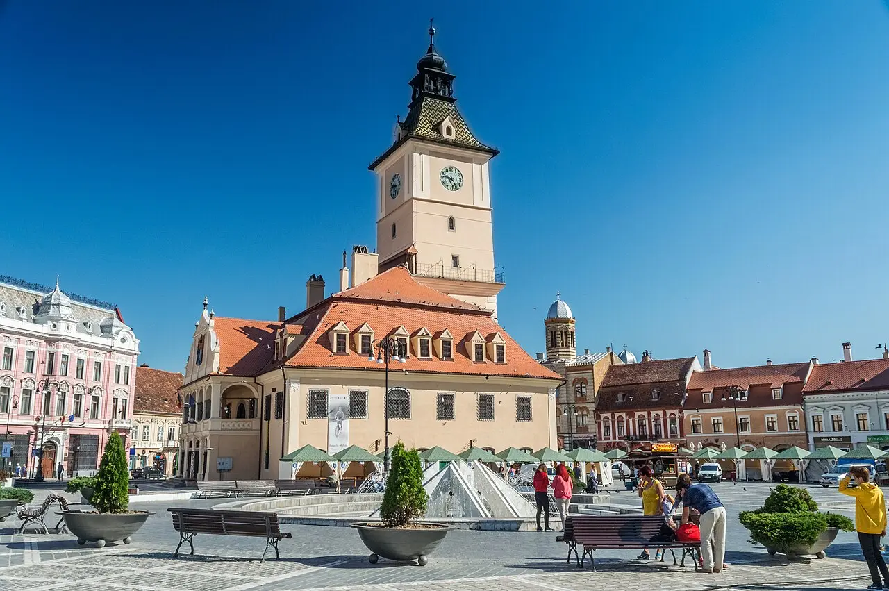 Cafe terraces filling Council Square in Brasov on a summer afternoon