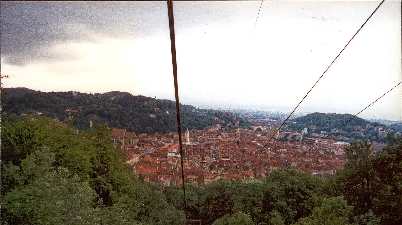 Brasov Old Town seen from Tampa mountain, red roofs around the Black Church with the mountains beyond