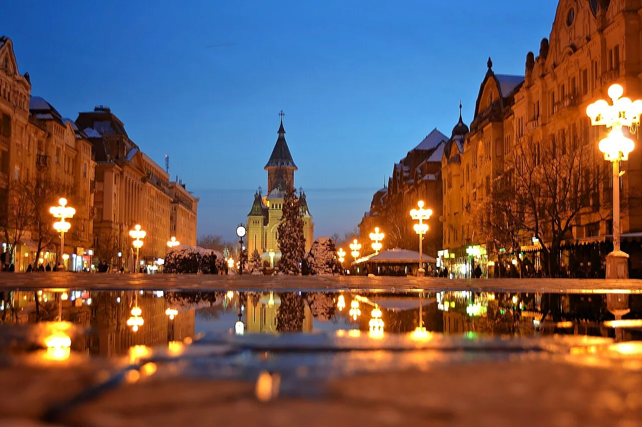 Piata Victoriei in Timisoara, the long central esplanade with flower beds running toward the tall Orthodox Metropolitan Cathedral at the far end