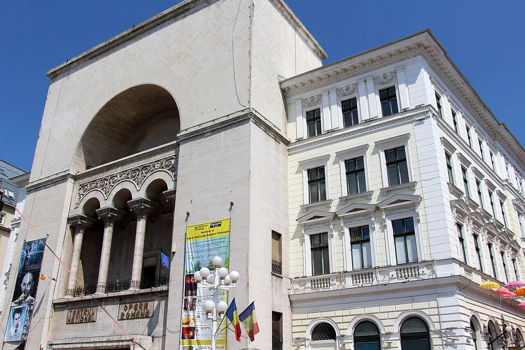 The National Theatre and Opera building at the head of Piata Victoriei in Timisoara, a large eclectic facade with arched windows