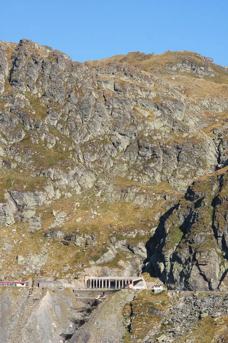 A driver-height view of the Transfagarasan hairpins stacked up the mountainside