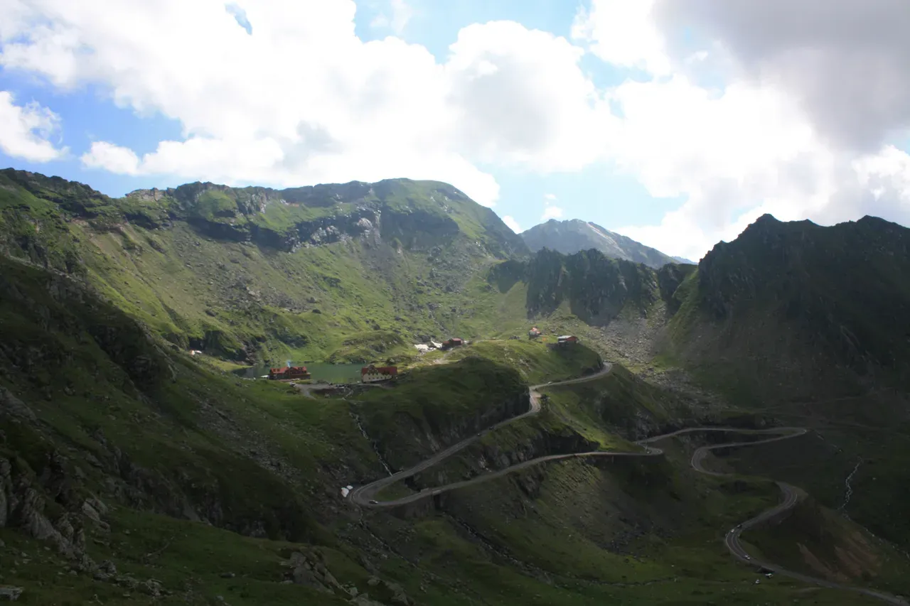 Balea Lake below the Fagaras peaks with the Transfagarasan road switchbacking up to it