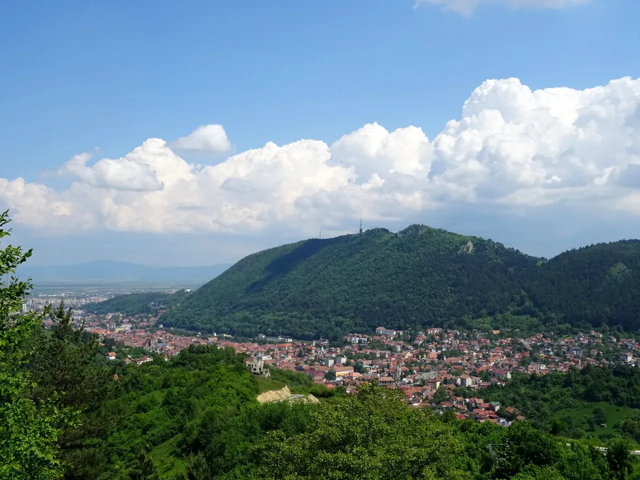Brasov old town spread below Tampa mountain, seen from the approach road
