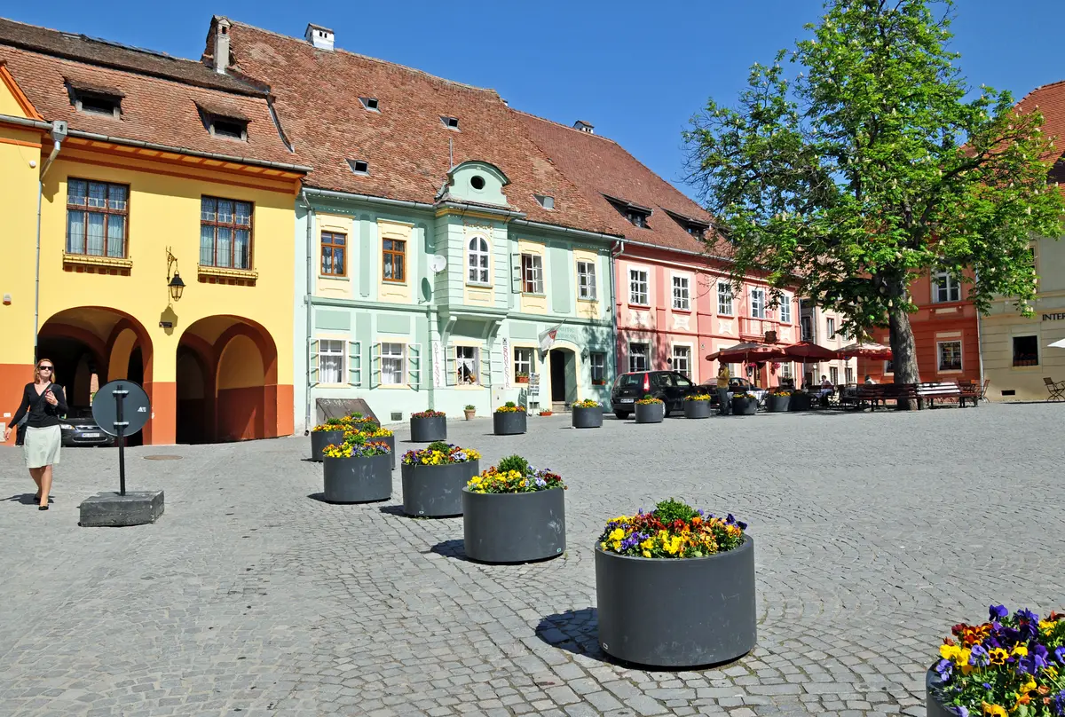 The cobbled Citadel Square of Sighisoara lined with colourful merchant houses